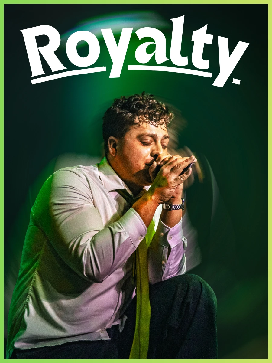 Royalty poster: vocalist kneeling with a microphone under green light